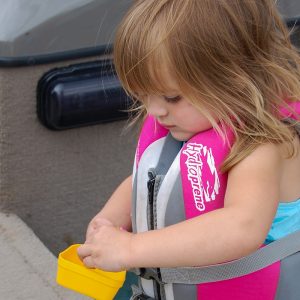 young female child with life jacket on a boat